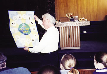 On behalf of the Jewish community, Bill Weismann accepts the Scarboro Missions Golden Rule poster during an interfaith service at Shaarey Zedek synagogue in Winnipeg. Multifaith activist Farida Lalbiharie has presented the poster to a number of faith communities in Winnipeg including Native Peoples, Sikhs, Muslims, Hindus and Buddhists.