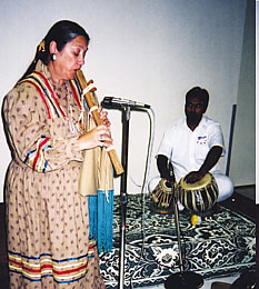 Native and Hindu faith representatives together give a musical presentation at the service.